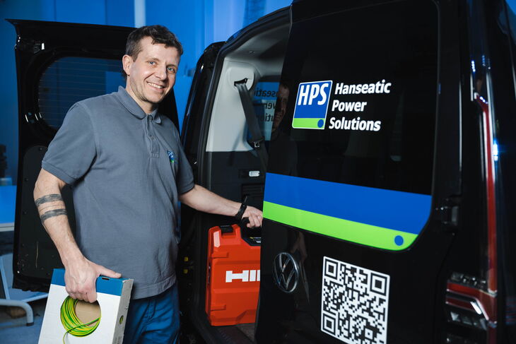 HPS - employee picks up tools from the service car